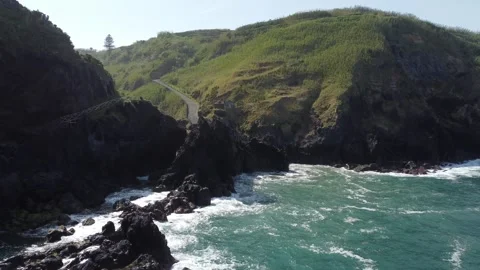 Aerial view of ocean waves crashing against dramatic cliffs of Sao Miguel island Stock Footage 340165138