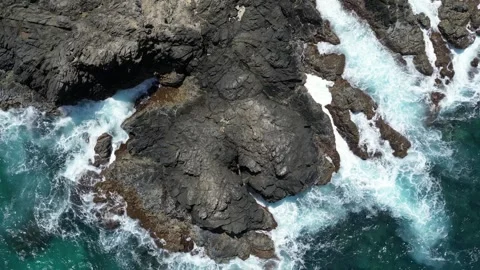 Aerial View of Ocean Waves Crashing on Rocky Coastline Stock Footage 340833064