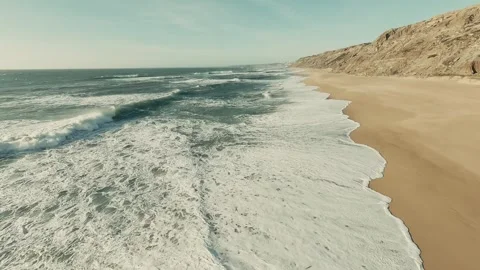 Aerial view of ocean waves crashing on sandy beach Video stock 341826219