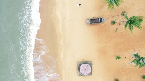 Aerial view of ocean waves crashing on a tropical sandy beach with palm trees Stock Footage 342003619