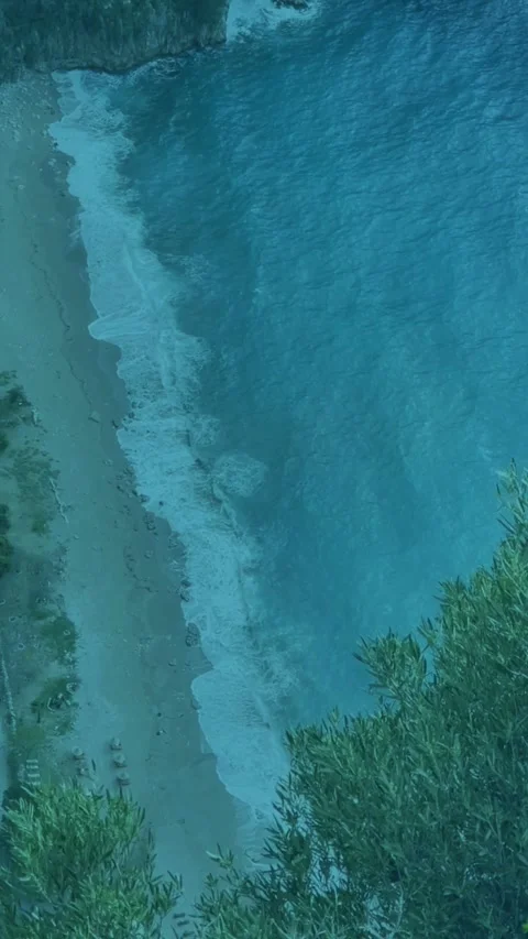Aerial View of Ocean Waves Crashing onto Shoreline at Sunset Stock Footage 342370930