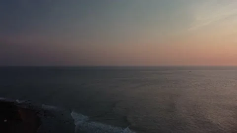 Aerial view of ocean waves hitting shore during sunrise in Montauk Stock Footage 221961457