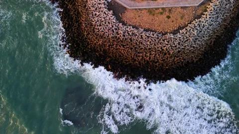 Aerial View of Ocean Waves Hitting Concrete Tetrapods Stock Footage 340553830