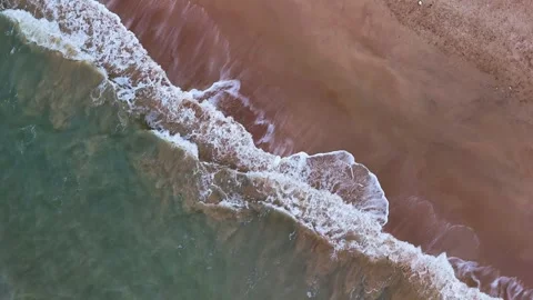 Aerial View of Ocean Waves Hitting Sandy Beach Shore with Blue Water Stock Footage 340553841