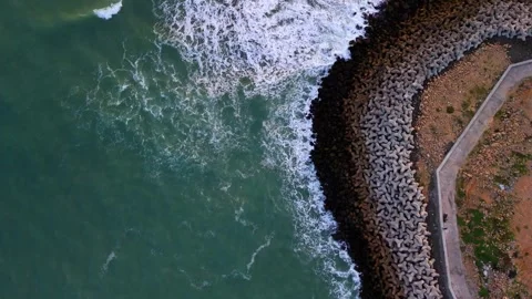 Aerial View of Ocean Waves Hitting Concrete Tetrapods Stock Footage 340553843