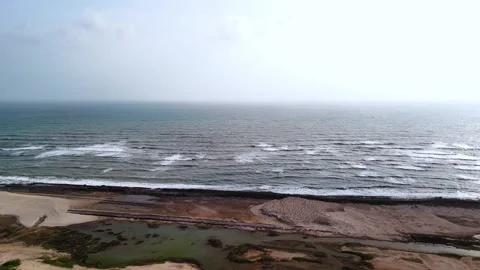 Aerial View of Ocean Waves Hitting Sandy Beach Shore with Blue Water Stock Footage 340553885