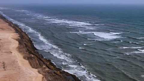 Aerial View of Ocean Waves Hitting Sandy Beach Shore with Blue Water Stock Footage 340553912