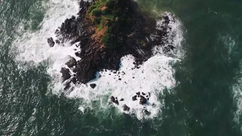 Aerial view of ocean waves pounding rocky shoreline on the Parrot Rock Stock Footage 346569201