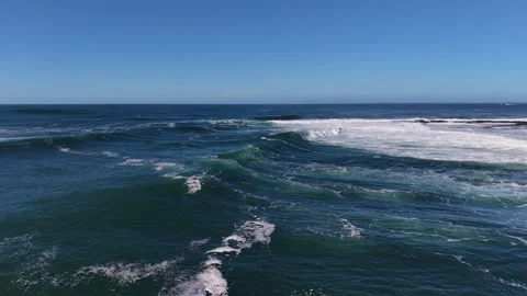 Aerial View of Ocean Waves Rolling Toward Sandy Shoreline Видео 333704129