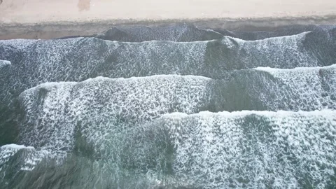 Aerial view of ocean waves rolling onto sandy beach in Huizhou Guangdong China Video stock 347039805