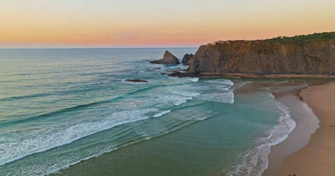 Aerial view of ocean waves sandy shoreline. Waves caress ocean edge, beauty Stock Footage 311111780