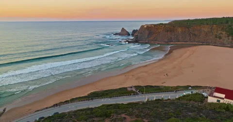 Aerial view of ocean waves sandy shoreline at sunset. Waves caress ocean edge Stock Footage 312268510