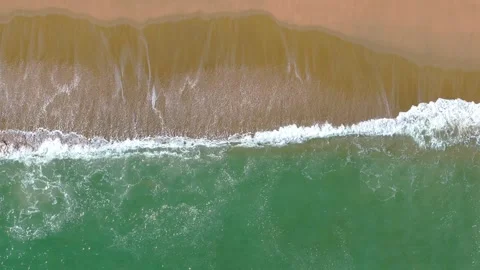 Aerial View of Ocean Waves at Sandy Beach Stock Footage 323504609