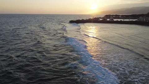 Aerial view of ocean waves at sunset Stock Footage 254265133