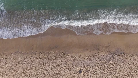 Aerial View of Ocean Waves Washing Sandy Beach from Drone Stock Footage 320930807