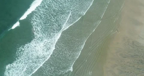 Aerial view of ocean waves washing onto sandy beach The Concept of summer v.. Stock Footage 335738465