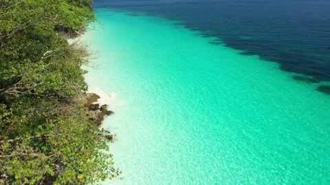 Aerial view of the ocean waves, white beaches and clear blue water and beautiful Stock Footage 130657394