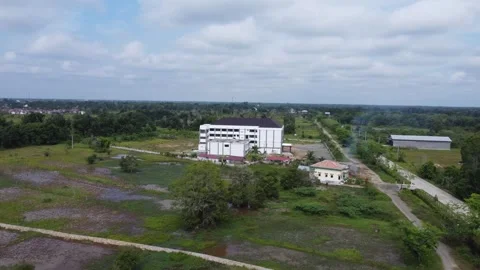 Aerial view of an office building under construction surrounded by agricult.. Stock Footage 317545514