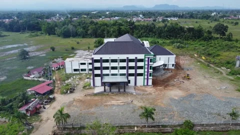 Aerial view of an office building under construction surrounded by agricult.. Stock Footage 317546054