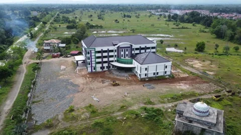 Aerial view of an office building under construction surrounded by agricult.. Stock Footage 317546109