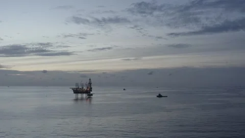 Aerial view of offshore jack up rig and offshore platform during sunset Stock Footage 320267698