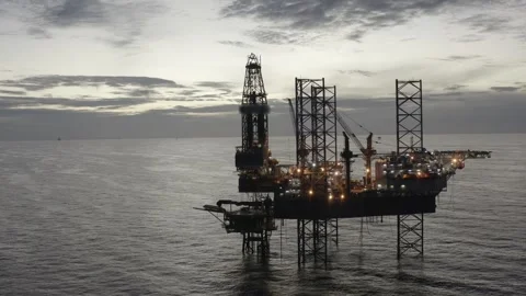 Aerial view of offshore jack up rig and offshore platform during sunset Stock Footage 320288080