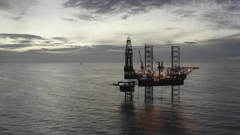Aerial view of offshore jack up rig and offshore platform during sunset Stock Footage 320288089