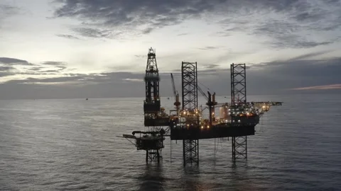 Aerial view of offshore jack up rig and offshore platform during sunset Stock Footage 320288092