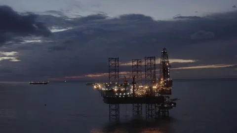 Aerial view of offshore jack up rig and offshore platform during sunset Stock Footage 320587104