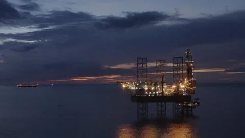 Aerial view of offshore jack up rig and offshore platform during sunset Stock Footage 320587105