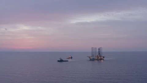 Aerial view of offshore jack up rig and offshore platform during sunset Stock Footage 320587772