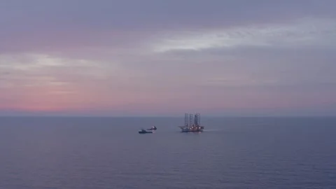 Aerial view of offshore jack up rig and offshore platform during sunset Stock Footage 320587781