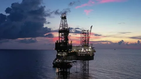 Aerial view of offshore jack up rig and offshore platform during sunset Stock Footage 320656543