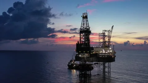Aerial view of offshore jack up rig and offshore platform during sunset Stock Footage 320656599