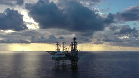Aerial view of offshore jack up rig and offshore platform during sunset Stock Footage 320969997