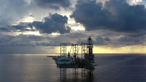 Aerial view of offshore jack up rig and offshore platform during sunset Stock Footage 320970179