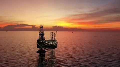 Aerial view of offshore jack up rig and offshore platform during sunset Stock Footage 321033744
