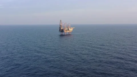 Aerial view of offshore jack up rig and offshore platform during sunset Stock Footage 322899257