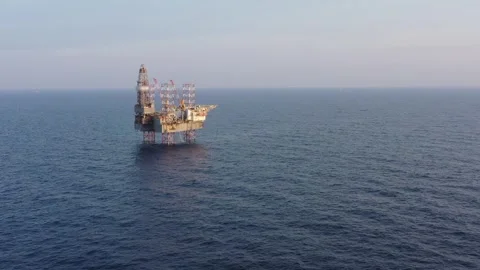 Aerial view of offshore jack up rig and offshore platform during sunset Stock Footage 322899472