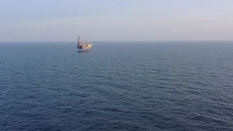 Aerial view of offshore jack up rig and offshore platform during sunset Stock Footage 322899489