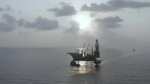 Aerial view of offshore jack up rig and offshore platform during sunset Stock Footage 323336904