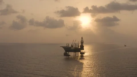 Aerial view of offshore jack up rig and offshore platform during sunset Stock Footage 323336909