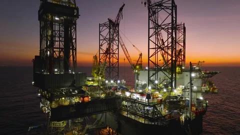 Aerial view of offshore jack up rig and offshore platform during sunset Stock Footage 323976799