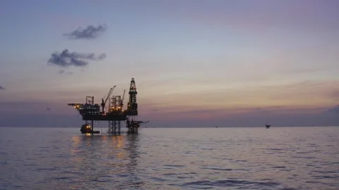 Aerial view of offshore jack up rig and offshore platform during sunset Stock Footage 324997059