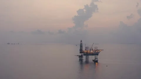 Aerial view of offshore jack up rig and offshore platform during sunset Stock Footage 325465959