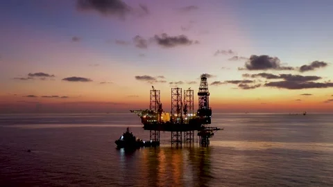 Aerial view of offshore jack up rig and offshore platform during sunset Stock Footage 327891504