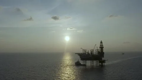 Aerial view of offshore jack up rig and offshore platform during sunset Видео 330555989