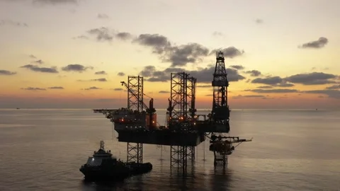 Aerial view of offshore jack up rig and offshore platform during sunset Stock Footage 332444920