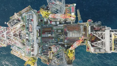 Aerial view of offshore jack up rig and offshore platform during sunset Stockbeeldmateriaal 338036048