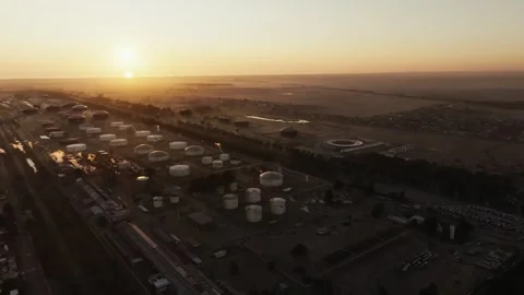 Aerial View of Oil Extraction Facility at Sunrise Capturing Industrial Calm Stock Footage 325964909
